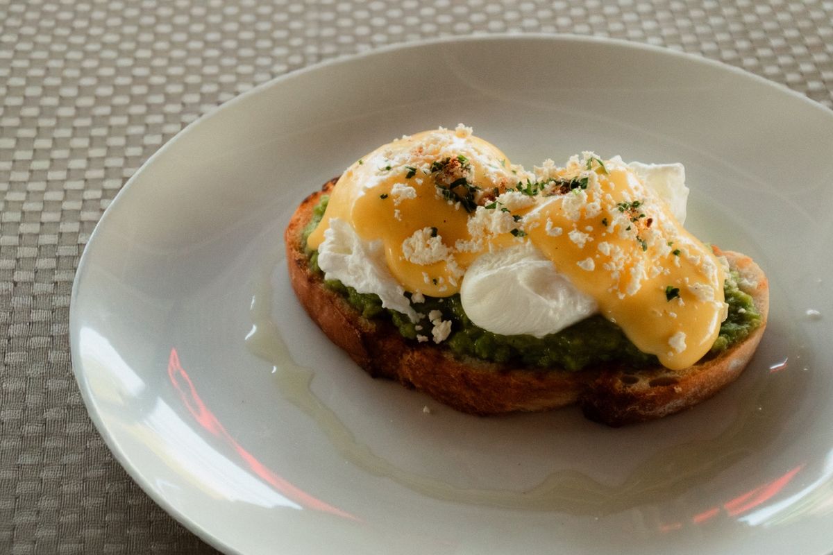 Avocado on toast with poached eggs and feta
